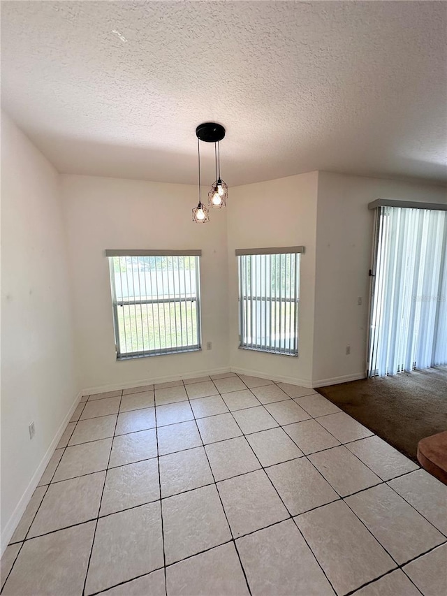 15 Ruth Dr, Palm Coast, FL 32164 - empty room with tile patterned floors, a textured ceiling, and baseboards