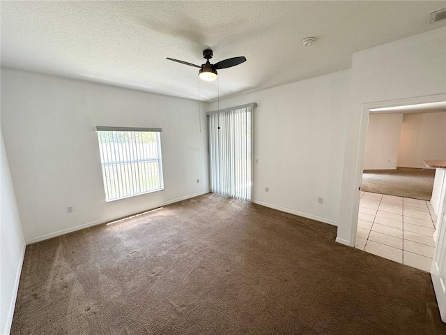 15 Ruth Dr, Palm Coast, FL 32164 - unfurnished room with carpet flooring, ceiling fan, a textured ceiling, baseboards, and a smoke detector