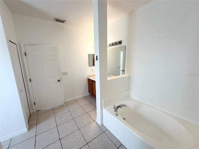 15 Ruth Dr, Palm Coast, FL 32164 - bathroom with vanity, a bath, tile patterned flooring, and baseboards