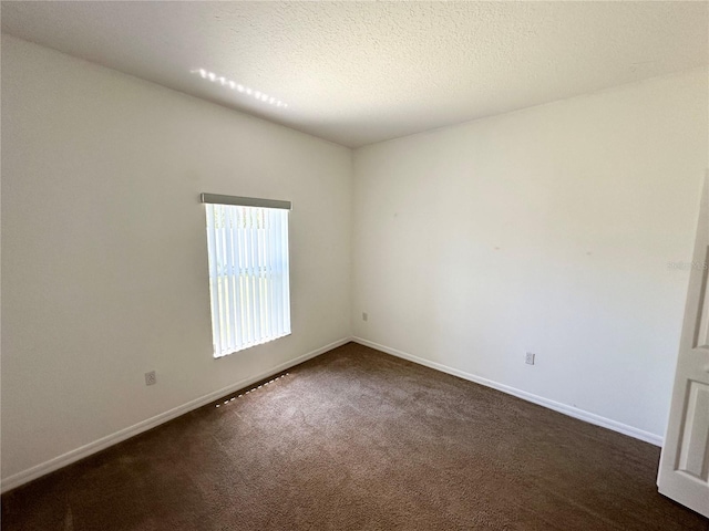 15 Ruth Dr, Palm Coast, FL 32164 - spare room with dark colored carpet, baseboards, and a textured ceiling