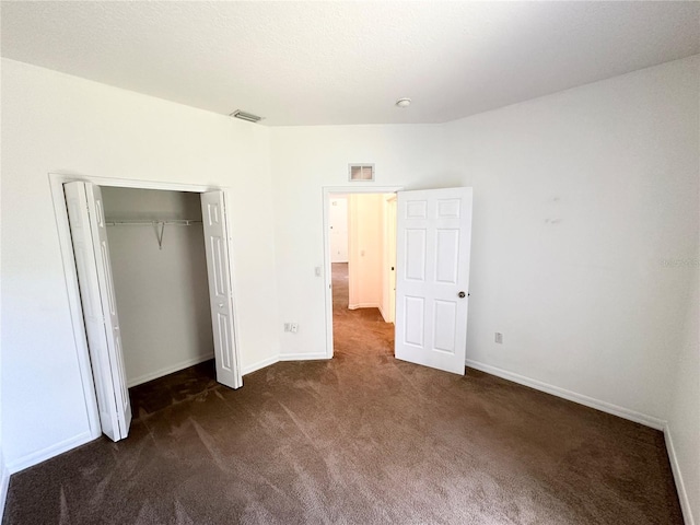 15 Ruth Dr, Palm Coast, FL 32164 - unfurnished bedroom featuring dark carpet, baseboards, and a closet