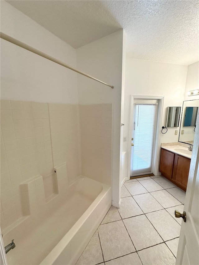 15 Ruth Dr, Palm Coast, FL 32164 - bathroom with tile patterned floors, vanity, a textured ceiling, and baseboards