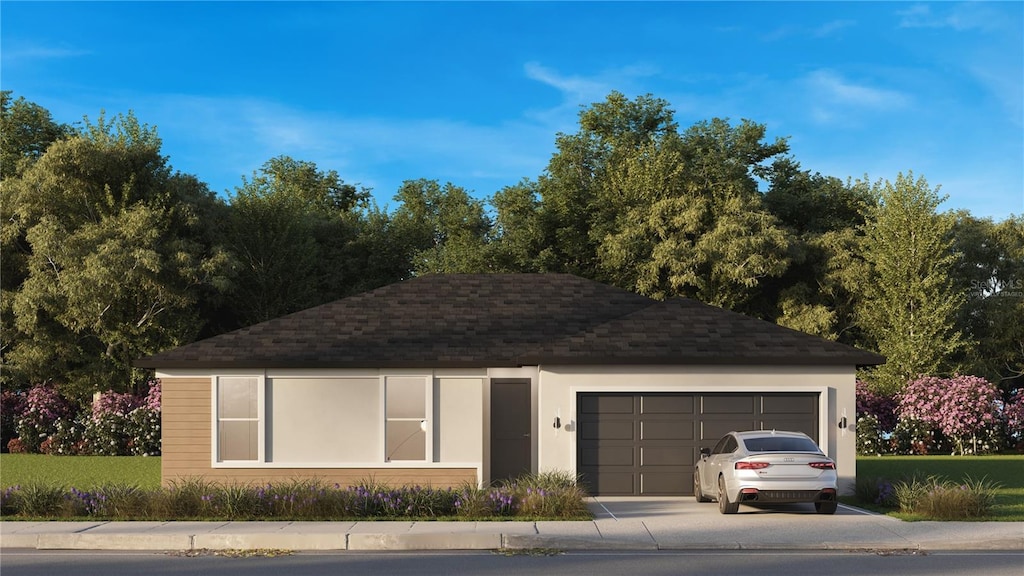 ranch-style house featuring roof with shingles, an attached garage, and driveway
