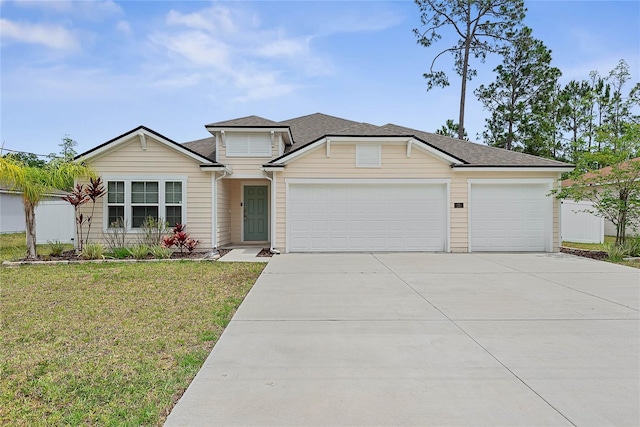 25 Red Top Ln, Palm Coast, FL 32164 - view of front of house with concrete driveway, an attached garage, and a front yard