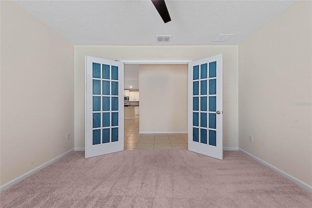 25 Red Top Ln, Palm Coast, FL 32164 - carpeted spare room with baseboards, tile patterned floors, a textured ceiling, and a ceiling fan