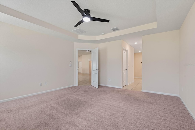25 Red Top Ln, Palm Coast, FL 32164 - spare room featuring light carpet, a ceiling fan, baseboards, a tray ceiling, and recessed lighting