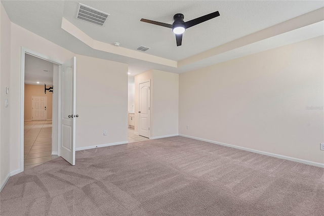 25 Red Top Ln, Palm Coast, FL 32164 - unfurnished bedroom with light colored carpet, baseboards, and a tray ceiling