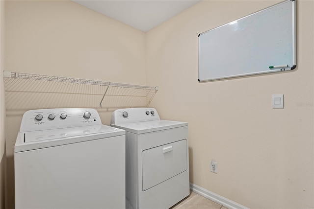 25 Red Top Ln, Palm Coast, FL 32164 - laundry area featuring washer and clothes dryer, baseboards, and light tile patterned flooring