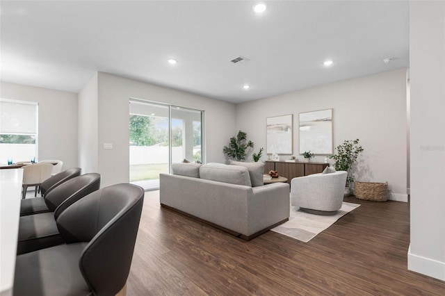 living area with wood finished floors, recessed lighting, and baseboards