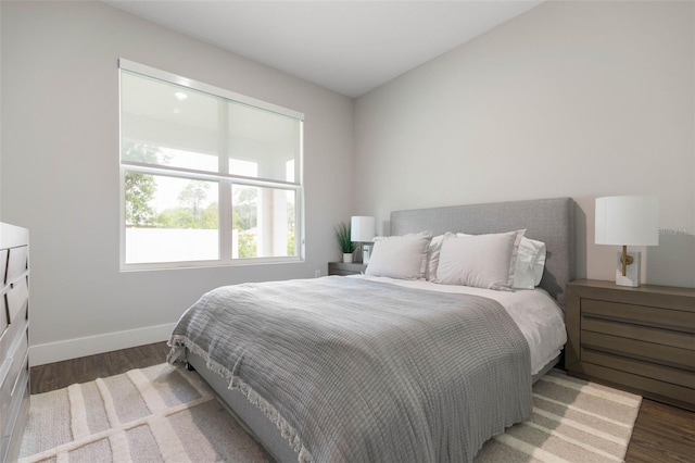 bedroom featuring baseboards and wood finished floors