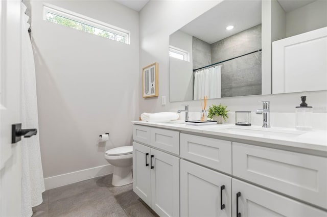 full bathroom featuring baseboards, toilet, tiled shower, double vanity, and finished concrete flooring