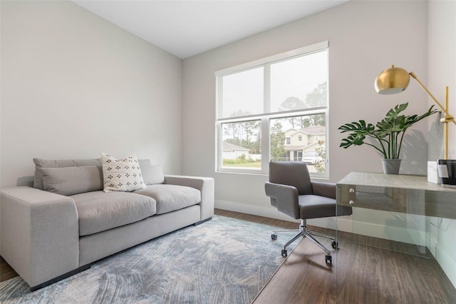 office area with baseboards and wood finished floors