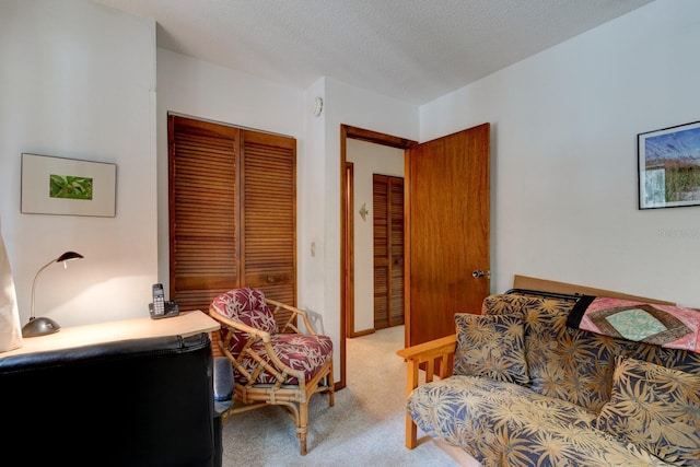 bedroom featuring light carpet and a closet