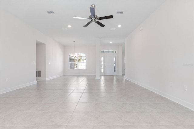 unfurnished living room with a ceiling fan, a chandelier, recessed lighting, light tile patterned floors, and baseboards