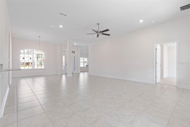 unfurnished living room with a chandelier, a ceiling fan, recessed lighting, light tile patterned flooring, and baseboards