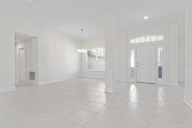 entrance foyer featuring light tile patterned floors, a chandelier, baseboards, and recessed lighting