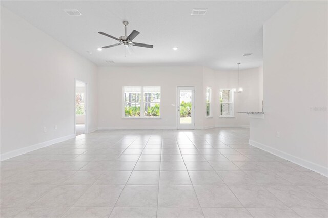 unfurnished room with light tile patterned flooring, a ceiling fan, a chandelier, baseboards, and recessed lighting