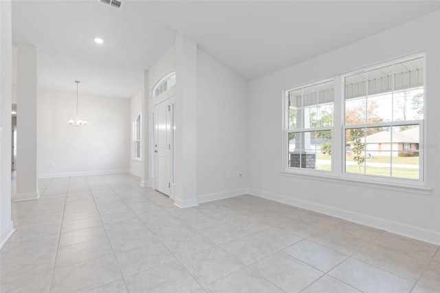 spare room with a chandelier, vaulted ceiling, baseboards, light tile patterned floors, and recessed lighting
