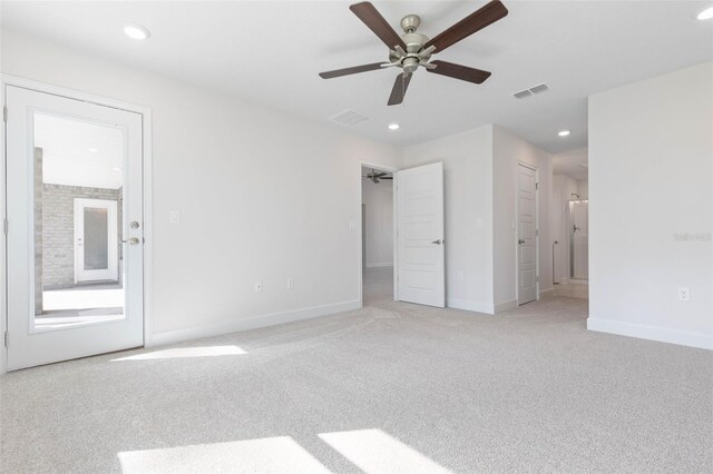 unfurnished bedroom featuring light colored carpet, recessed lighting, baseboards, ensuite bathroom, and ceiling fan