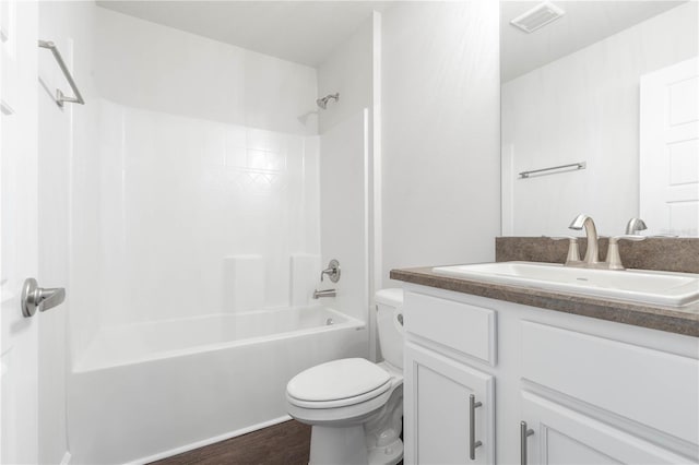 bathroom featuring toilet, bathtub / shower combination, vanity, and wood finished floors