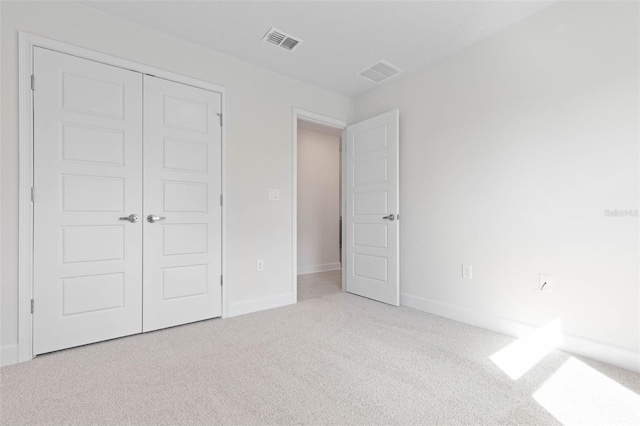 unfurnished bedroom featuring carpet flooring, a closet, and baseboards