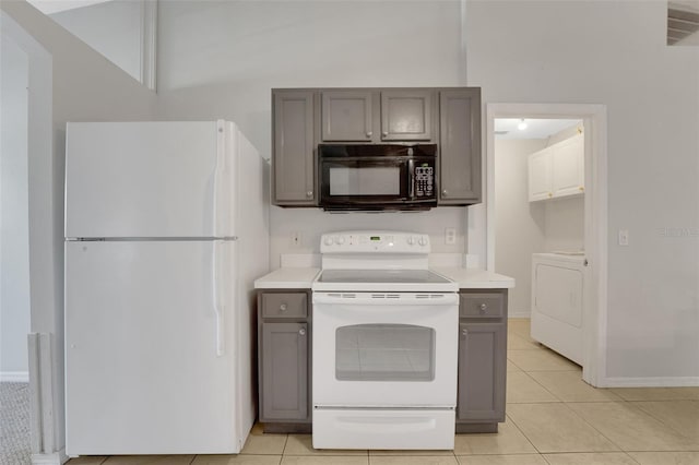 kitchen with white appliances, washer / dryer, and gray cabinets