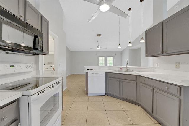 kitchen with white appliances, a ceiling fan, gray cabinetry, a sink, and a peninsula