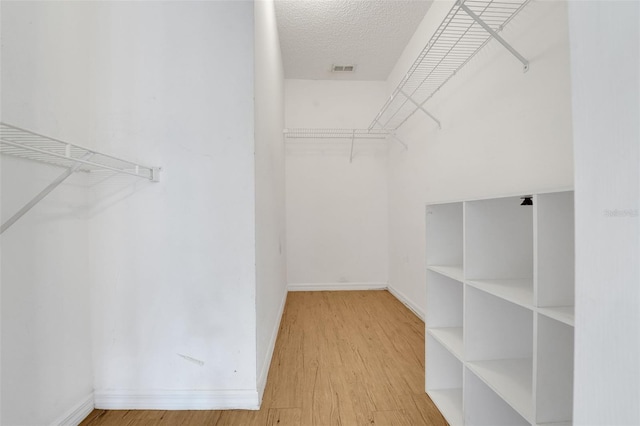 spacious closet with wood finished floors