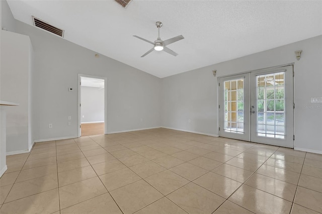 spare room featuring lofted ceiling, ceiling fan, french doors, light tile patterned floors, and baseboards