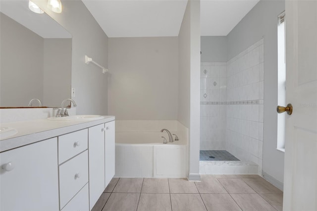 bathroom featuring tile patterned floors, tiled shower, a garden tub, and double vanity