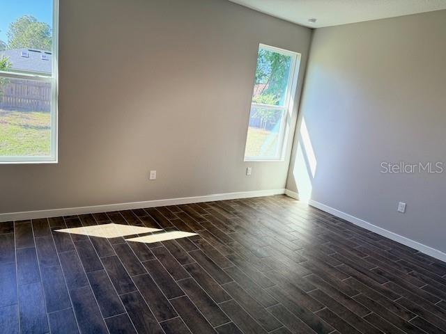 43 Whittingham Ln, Palm Coast, FL 32164 - unfurnished room with dark wood finished floors and baseboards