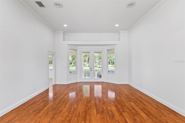 unfurnished room featuring french doors, baseboards, wood finished floors, crown molding, and recessed lighting