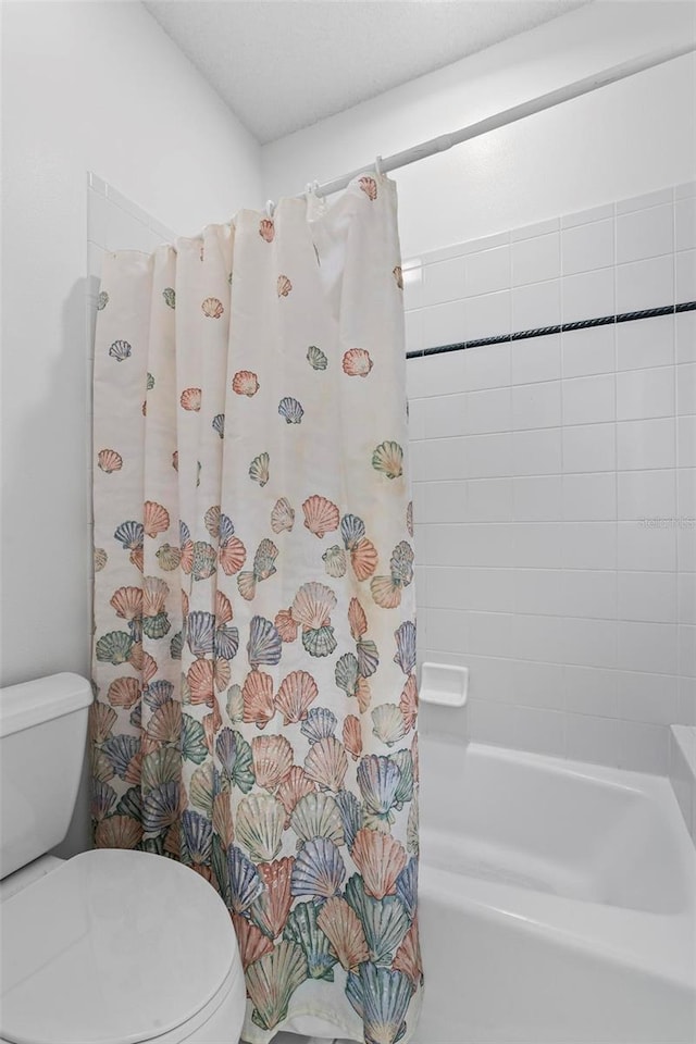 bathroom featuring toilet and shower / bath combo