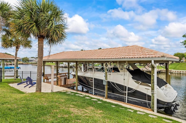 dock area with boat lift and a water view