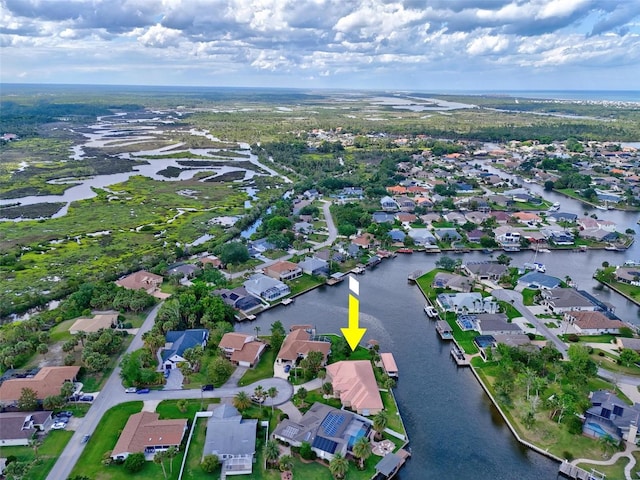 aerial view of property and surrounding area featuring nearby suburban area and a nearby body of water