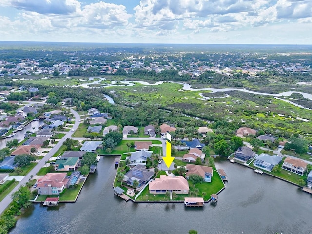 aerial overview of property's location featuring nearby suburban area and a nearby body of water