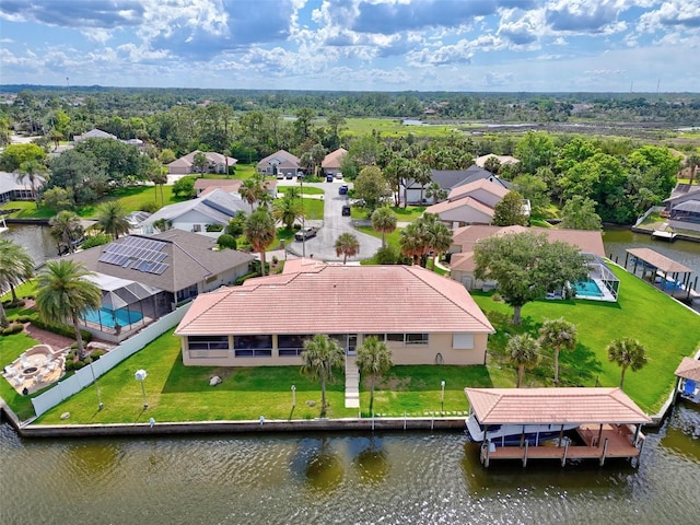 aerial view of residential area featuring a large body of water
