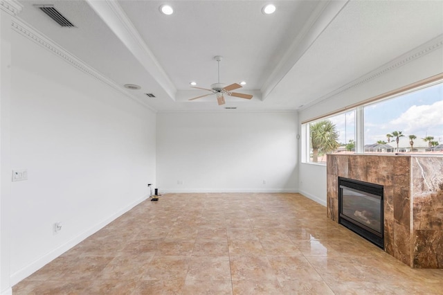 unfurnished living room with a raised ceiling, recessed lighting, a tile fireplace, a ceiling fan, and crown molding