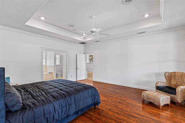 bedroom with a raised ceiling, crown molding, wood finished floors, recessed lighting, and baseboards