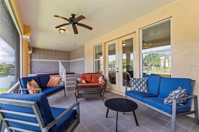 view of patio / terrace featuring french doors, an outdoor living space, and ceiling fan
