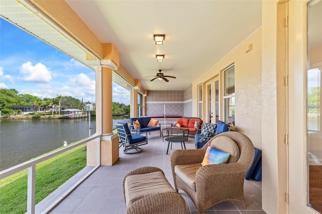 view of patio with a water view, an outdoor hangout area, ceiling fan, and french doors