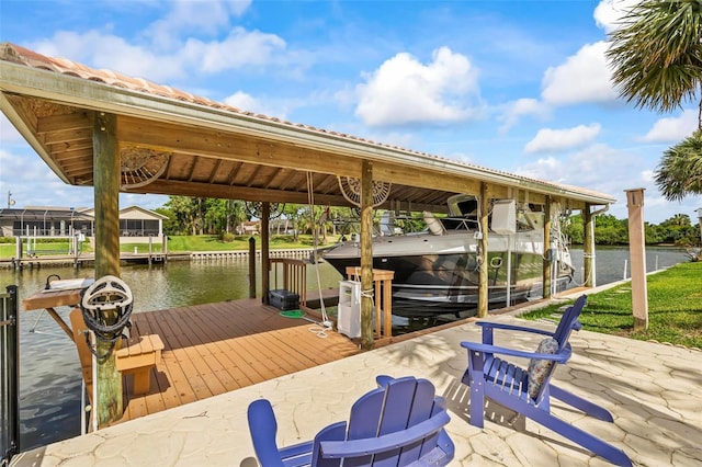 dock area with boat lift and a water view