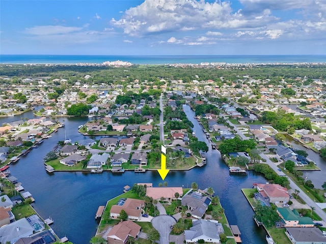 aerial view of property's location with nearby suburban area and a nearby body of water