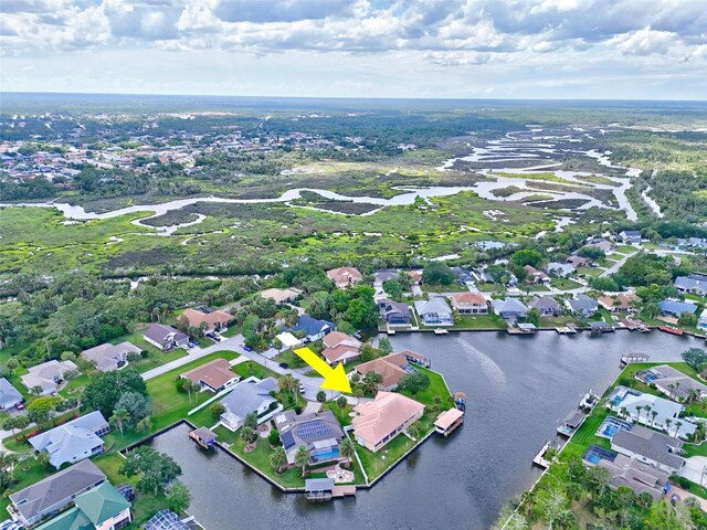 aerial view of property and surrounding area featuring a large body of water and nearby suburban area