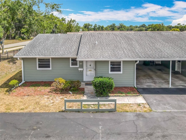 244 Oakleigh Dr Unit 200, Deland, FL 32724 - view of front of property featuring a shingled roof, an attached carport, fence, and asphalt driveway