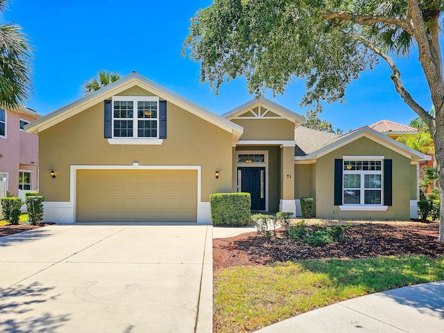 71 N Riverwalk Dr, Palm Coast, FL 32137 - view of front of home with stucco siding, concrete driveway, and a garage