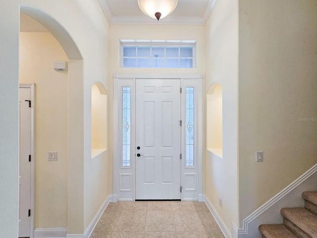 71 N Riverwalk Dr, Palm Coast, FL 32137 - tiled foyer entrance featuring arched walkways, baseboards, crown molding, a high ceiling, and stairs