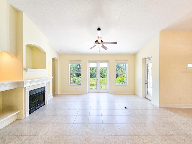 71 N Riverwalk Dr, Palm Coast, FL 32137 - unfurnished living room featuring a ceiling fan, plenty of natural light, a fireplace, and light tile patterned floors