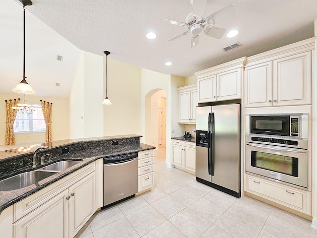 71 N Riverwalk Dr, Palm Coast, FL 32137 - kitchen with appliances with stainless steel finishes, a sink, arched walkways, a ceiling fan, and pendant lighting