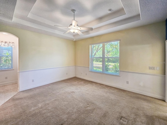 71 N Riverwalk Dr, Palm Coast, FL 32137 - carpeted spare room featuring a tray ceiling, a textured ceiling, ceiling fan, and baseboards